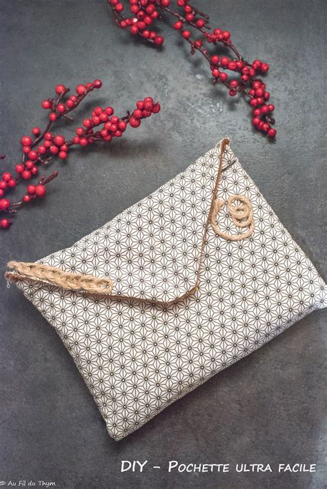 A White Purse Sitting On Top Of A Table Next To Berries And Red Berries