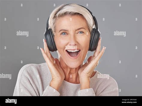 One Happy Mature Woman Isolated Against A Grey Background In A Studio