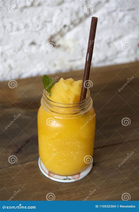 Glass Of Fresh Mango Smoothie On A Wooden Table Stock Photo Image Of