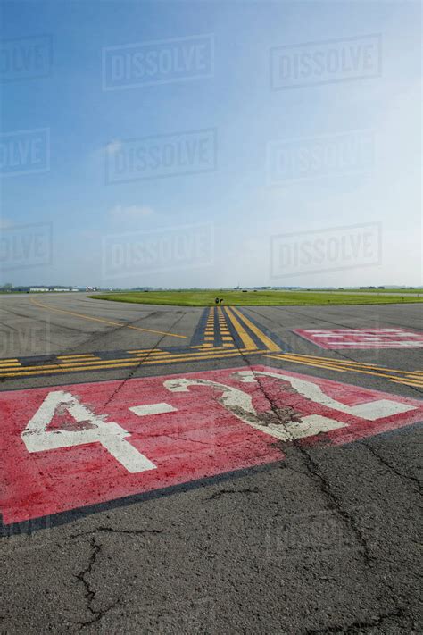 Markings on airplane runway - Stock Photo - Dissolve