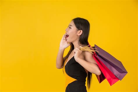 Free Photo Shopping Beautiful Woman Holding A Colorful Paper Bag On A