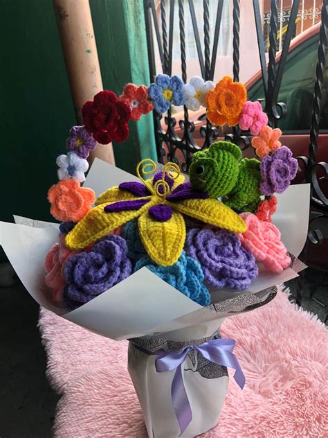 A Bouquet Of Colorful Crocheted Flowers In A White Vase On A Pink Rug