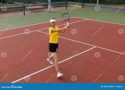 Professional Equipped Female Tennis Player Beating Hard The Tennis Ball