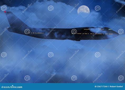 A Passenger Jet An Airliner Is Seen Flying Though Clouds And Night