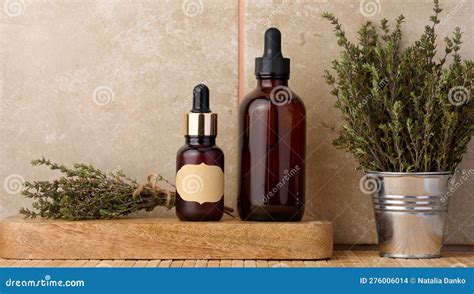 Thyme Essential Oil In Glass Bottle With Dropper And Fresh Thyme Sprigs