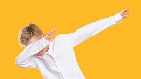 Premium Photo Dab Gesture Dance Move Amused Boy Raising Arms