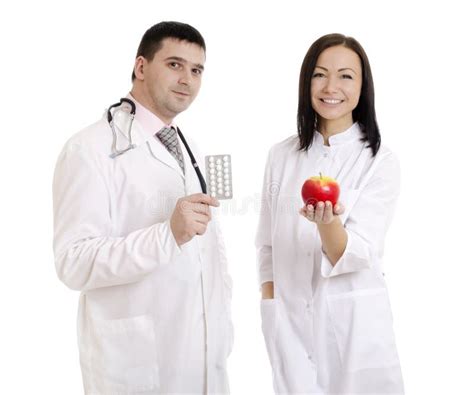 Male And Female Doctors Holding Apple And Pills Stock Image Stock