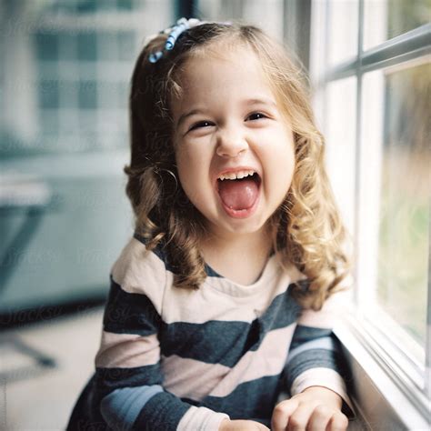 Adorable Young Girl With A Cute Expression On Her Face By Stocksy