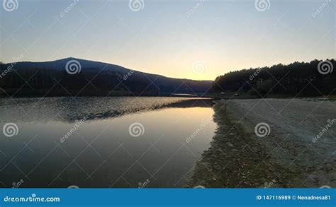 Sunset On A Peaceful Lake Shore Stock Image Image Of Water Lake