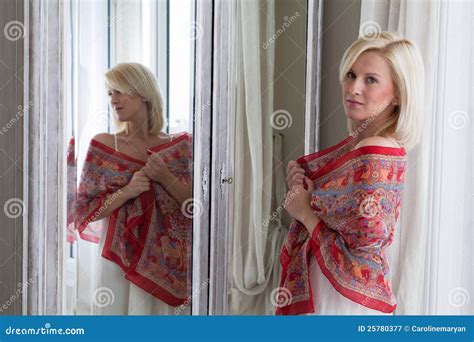 Beautiful Woman Standing In Front Of Mirror Royalty Free Stock