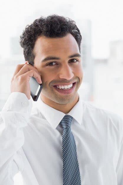 Premium Photo Smiling Elegant Young Businessman Using Cellphone