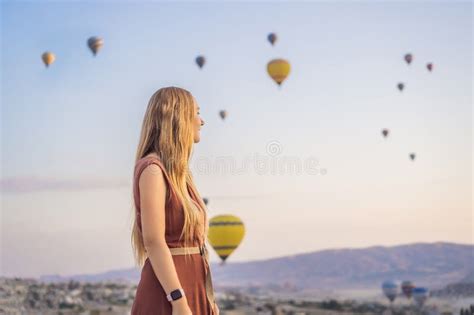 Tourist Woman Looking At Hot Air Balloons In Cappadocia Turkey Happy Travel In Turkey Concept
