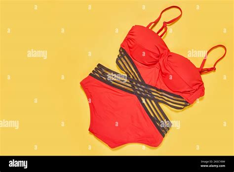 Two Red Swimsuits One With Black Straps And The Other With Grey