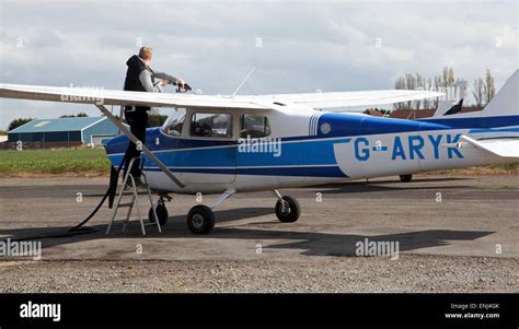 A Cessna 172 Light Aircraft Being Refueled At A Flying Club Airfield