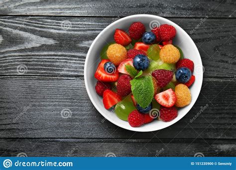 Salada De Fruto Deliciosa Na Bacia Na Tabela De Madeira Escura Foto De