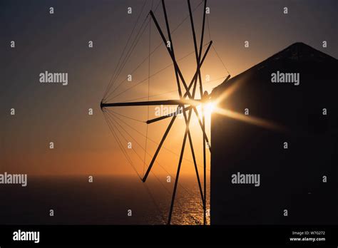 Windmill silhouette in front of the sunset Stock Photo - Alamy