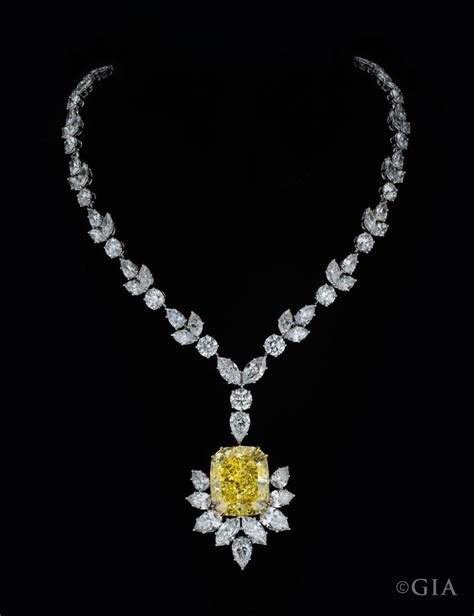 A 54 29 Ct Fancy Intense Yellow Diamond Suspended From A Necklace Set