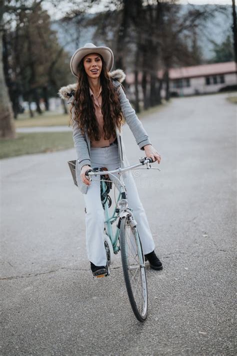 Confident Businesswoman With Bicycle Enjoying A Break In The Park Stock