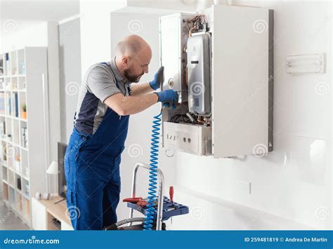 Professional Engineer Servicing A Boiler At Home Stock Image Image Of