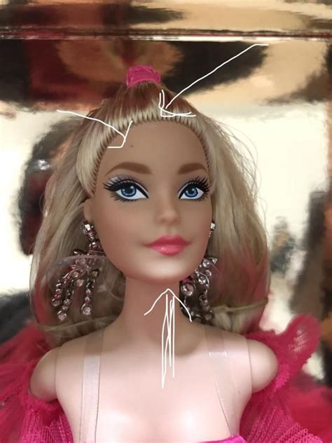 a close up of a barbie doll with blonde hair and blue eyes wearing pink ...