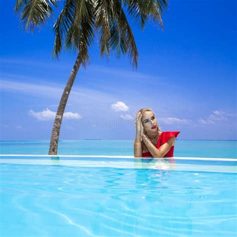 Elegant Woman In The Red Bikini On The Sun Tanned Slim And Shapely Body