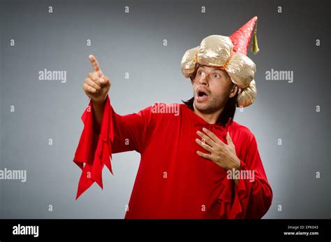 Funny wizard wearing red dress Stock Photo - Alamy