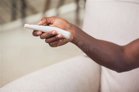 Man Holding Remote Control On Couch Stock Image Image Of Domestic