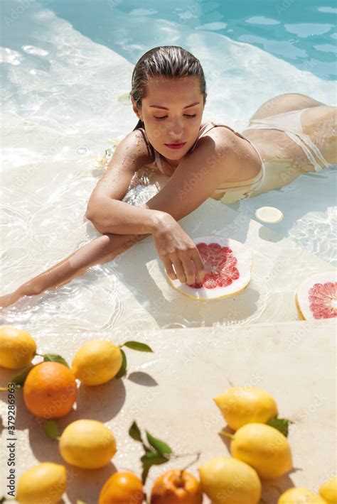 Beautiful Model S Portrait In Pool With Citrus Woman In Bikini Enjoying Fresh Exotic Fruit At