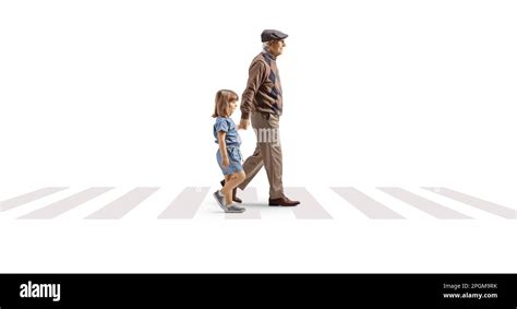 Full Length Profile Shot Of A Grandfather Crossing Street With A Child