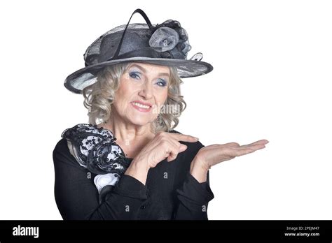 Happy Gorgeous Mature Woman In Hat Showing Something Stock Photo Alamy