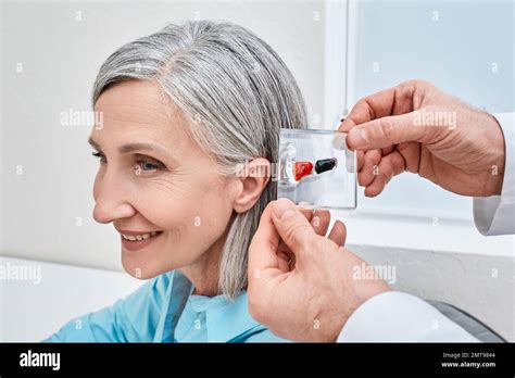 Invisible In The Canal Hearing Aids Doctor Demonstrates Display Stand