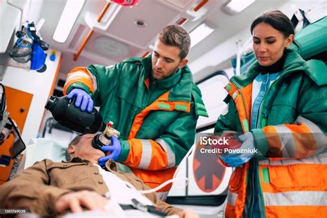 Unconscious Senior Man And Working Paramedics In The Ambulance Stock