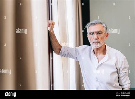Mature Man Standing By Window In Hotel Room Stock Photo Alamy