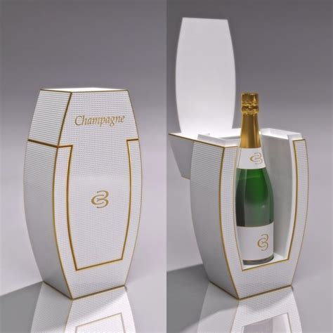 A Champagne Bottle In A White Box With Gold Trimmings On The Top And Bottom