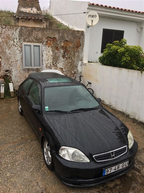 a black car parked in front of a house