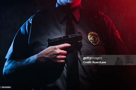 Police Officer Holding Gun High-Res Stock Photo - Getty Images