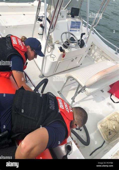 Two Members From Coast Guard Station Marathon Help Dewater A 20 Foot Rental Vessel Monday July