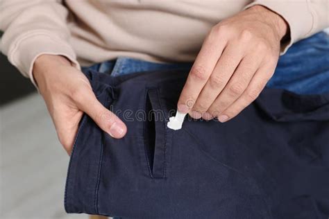 Man Removing Chewing Gum From Black Jeans Closeup Stock Photo Image