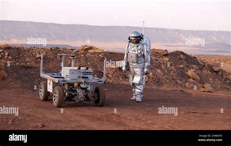 An Analog Astronaut Clad In A Specialized Spacesuit Walks Around A