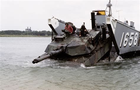 A Marine M1a1 Main Battle Tank Moves Down The Ramp Of Utility Landing Craft Lcu 1658 Into The