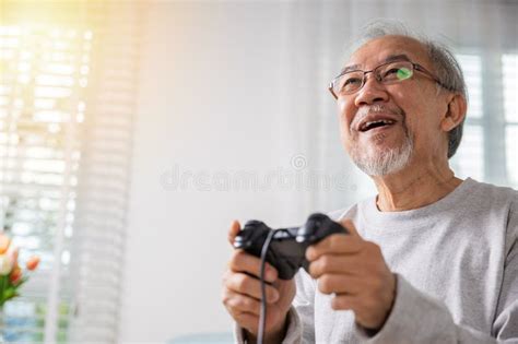 Asian Mature Man Hands Using Game Controller Play Videogame Stock Photo