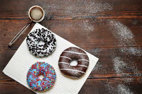 Premium Photo Fresh Donuts Sprinkled With Powdered Sugar On Wooden