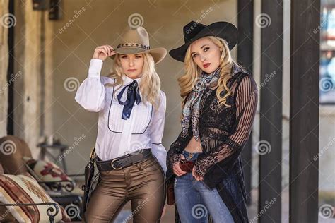 Two Lovely Blonde Models Dressed As Cowgirls Enjoys The American West