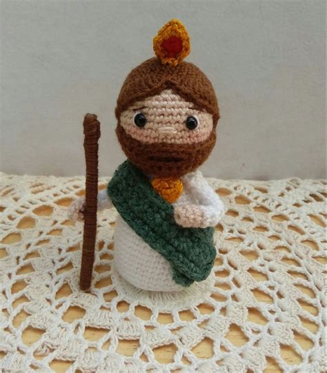 A Crocheted Doll Is Holding A Stick