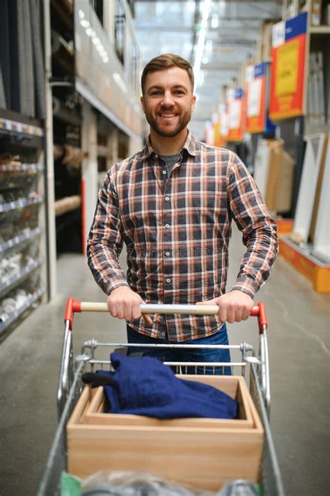 Portrait Of Happy Mature Man Standing In Hardware Store Stock Photo