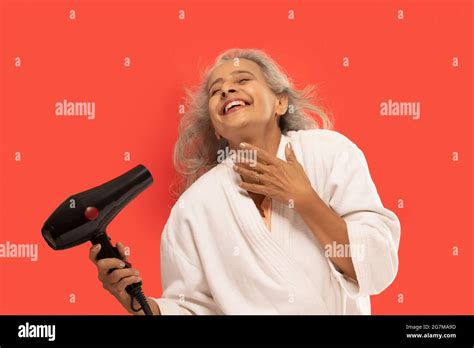 Senior Woman Blow Drying Hair Hi Res Stock Photography And Images Alamy