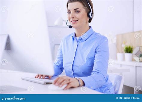 Serious Pretty Young Woman Working As Support Phone Operator With