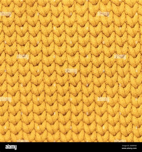 Yellow mustard color knitted fabric texture background Stock Photo - Alamy