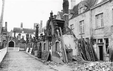 An Old Black And White Photo Of A Building That Has Been Torn Down In Half