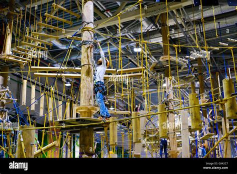 Children age 6-12 attend indoor adventure climbing park Stock Photo - Alamy